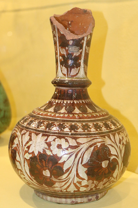 Unknown Indian artist, Red earthenware vase with four circular panels on body and formal and leaf borders in cream and dark brown slip (19th century), The Potteries Museum & Art Gallery STKMG:CER2533. Photo Credit: The Potteries Museum & Art Gallery