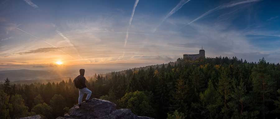 Image of a man and the sunrise on a hilltop for the Heritage and Health event at IIICH