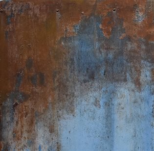 A rusted metal plate or wall