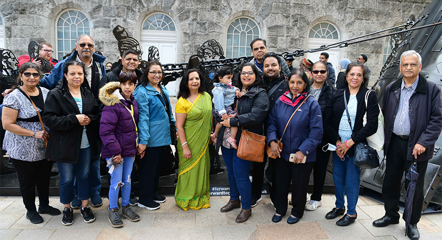 A group of people in front of the Forward Together monument