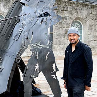 Raaj Shamji in front of the Forward Together monument