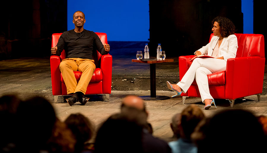 Adrian Lester being interviewed on stage