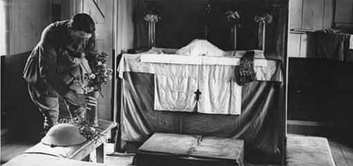 Photograph of a padre setting an altar
