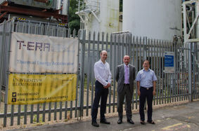 Eddie Hughes MP (centre) with Dr Jonathan Radcliffe (left) and Dr Yongliang Li standing in front of Birmingham’s liquid air energy storage (LAES) demonstration plant