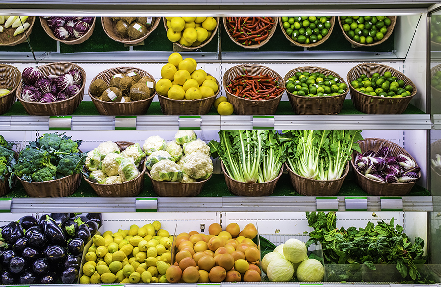 Supermarket refrigerator with fresh fruit and vegetable on shelves