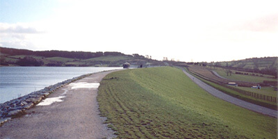Grass-covered embankment next to water