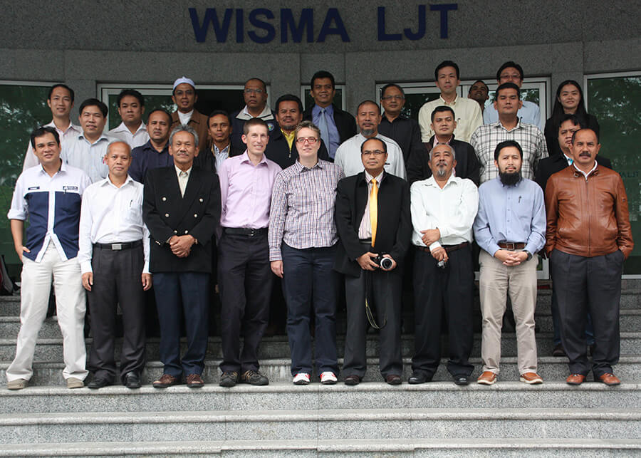 NBIF researchers standing with a group outside WISMA LJT