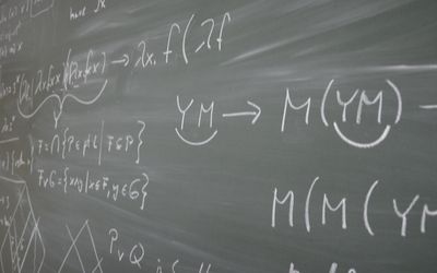 Image of mathematical equations on chalk board