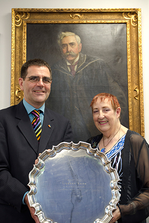 Peter Gardner Head of Electronic, Electrical and Systems Engineering, with Elinor Kapp, granddaughter of Professor Gisbert Kapp, standing in front of a portrait of her grandfather