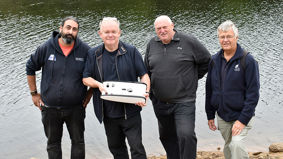 Members of the HIT Team by Burrator Reservoir with Professor Bob Stone holding mini remotely operated vehicles