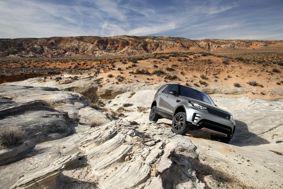 Land Rover SUV driving on all-terrain environment