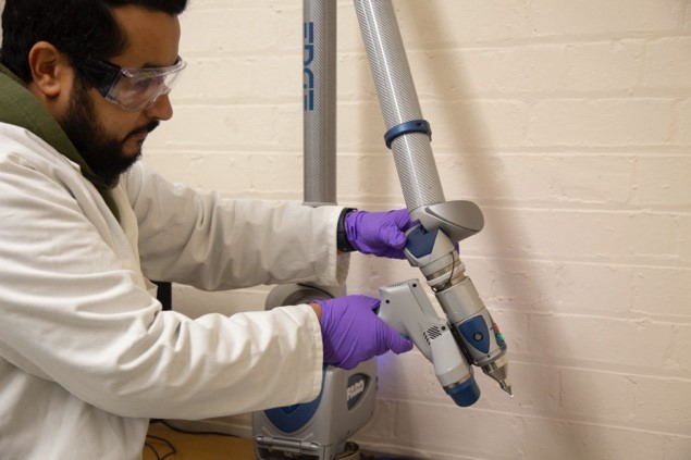 A technician using laser 3D scanning and material characterisation facilities
