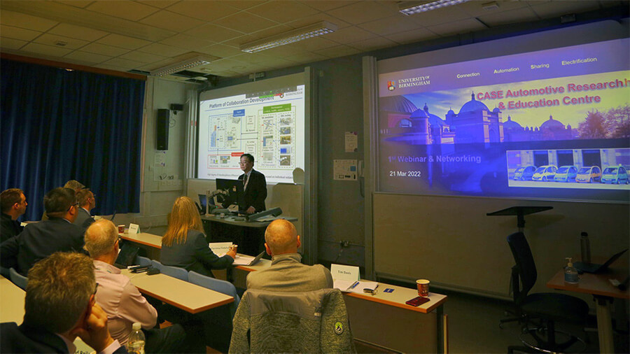 Person delivering presentation to a room of academics