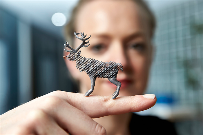 Female holding 3D printed reindeer model on her finger