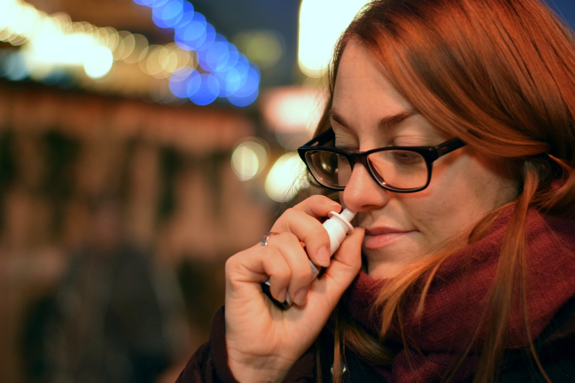 Woman using nasal spray