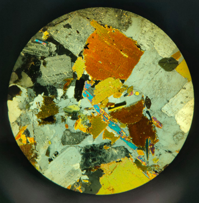 Photograph of a mineral thin section down a microscope