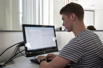 A student at a PC during a python computing class