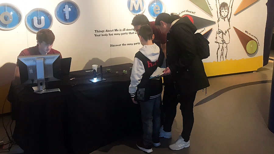 A parent and child taking part in a science experiment being delivered by students from the Physical Sciences for Health (Sci-Phy) Centre at the Thinktank Birmingham science museum