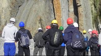 Group of Geoscience students examining natural rock formations
