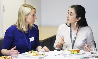 Global Health Research Network Image of two ladies eating at an event