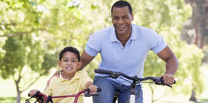 father and son on bicycles