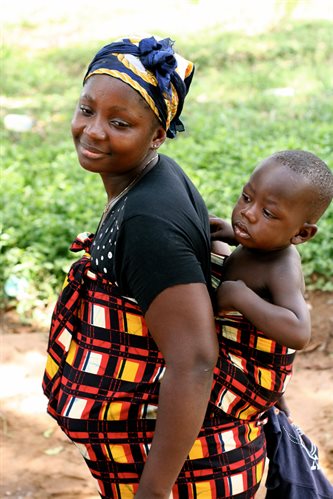 african mother with baby on back