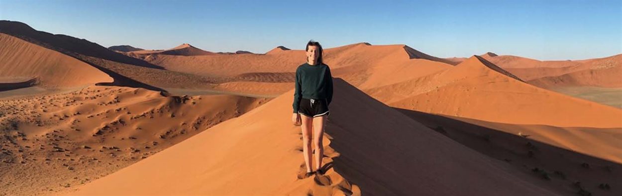 Alexandra Victor standing on sand dunes