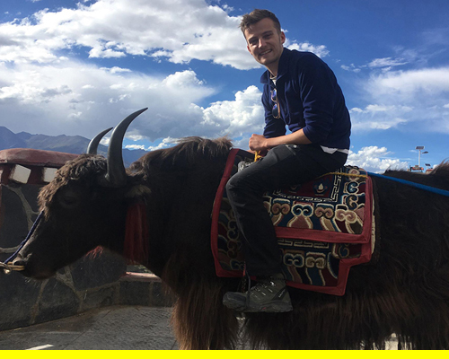 Medical student riding a Yak