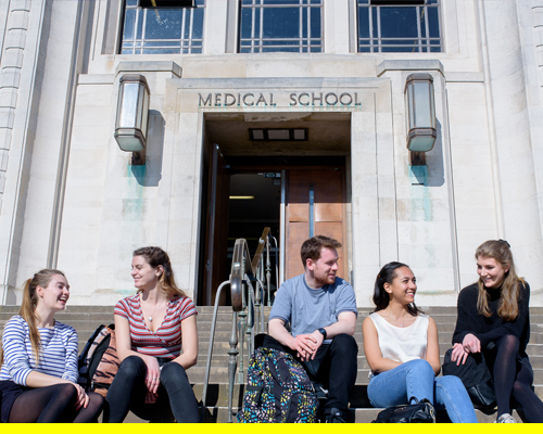Two male and three female medical students outside the medical school