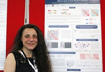 Woman standing in front of her poster at the BCGB 2019 Symposium