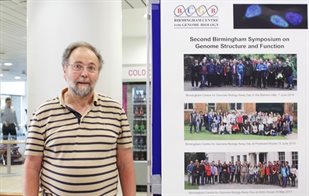 Professor Peter Cockerill standing in front of a poster at the BCGB Symposium
