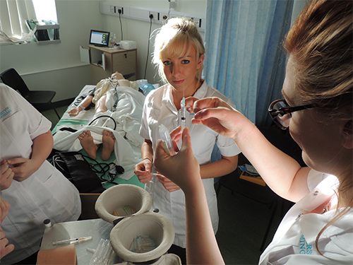 Student nurses with equipment