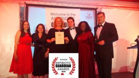 BactiVac team Antibiotic Guardian Awards onstage with logo