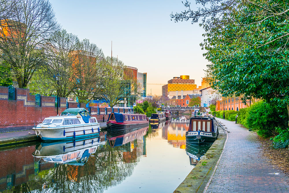 Canal boats in Birmingham with the city library in the background