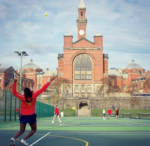 Students playing tennis with Aston Webb building in the background
