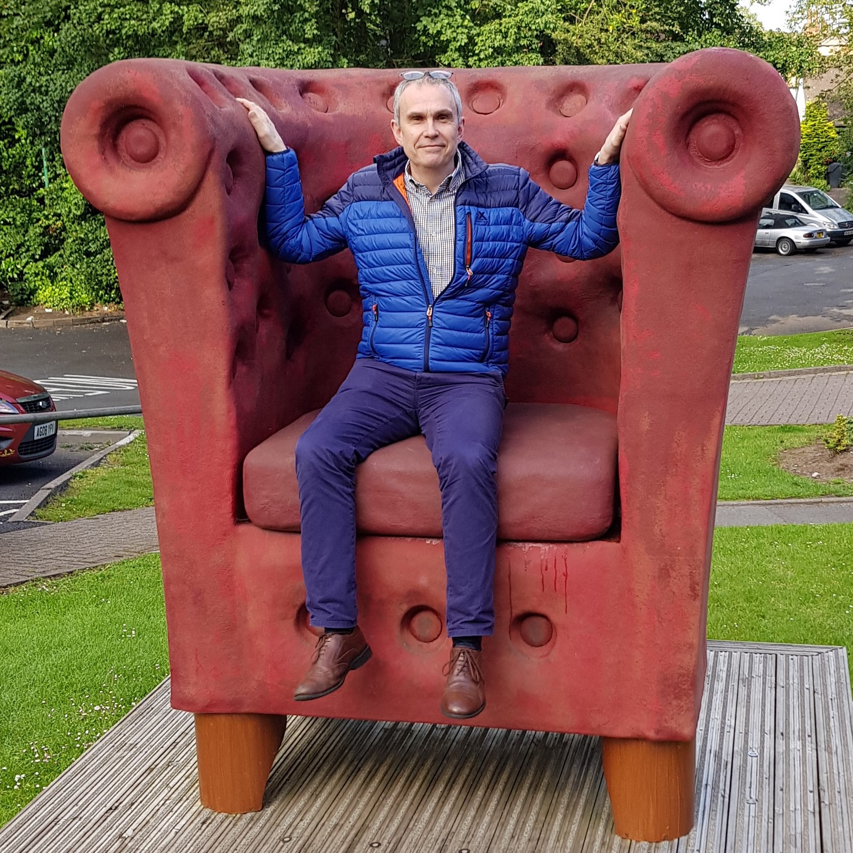 Mike Milward sitting on a giant chair