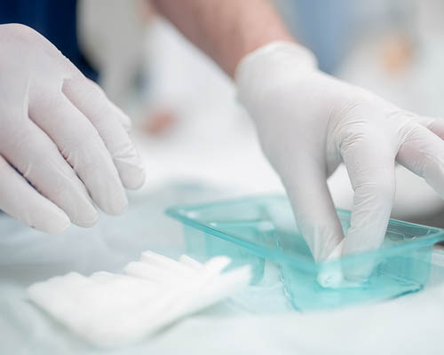 Nurse sorting swabs in a plastic container