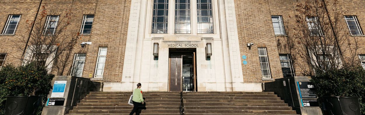 Medical School with a person walking up the steps