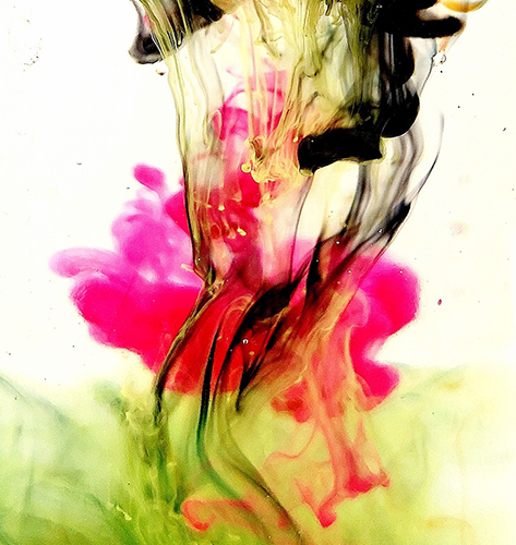 Black, pink and green inks and pigments in water.