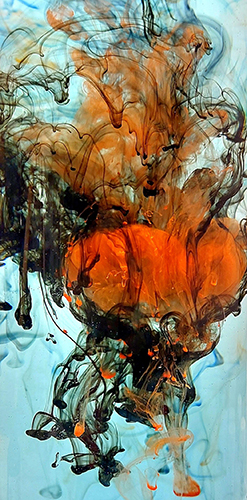 Orange, black and blue inks and pigments in water.