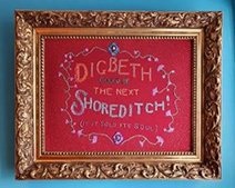 A framed picture of “Digbeth is the next Shoreditch” embroidery.
