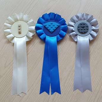 Three rosettes with Lego in the centre