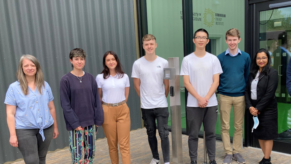 A group of Birmingham Energy Institute and Tyseley Energy Park interns gather outside the Birmingham Energy Innovation Centre with Dr Emily Prestwood standing on the far left.