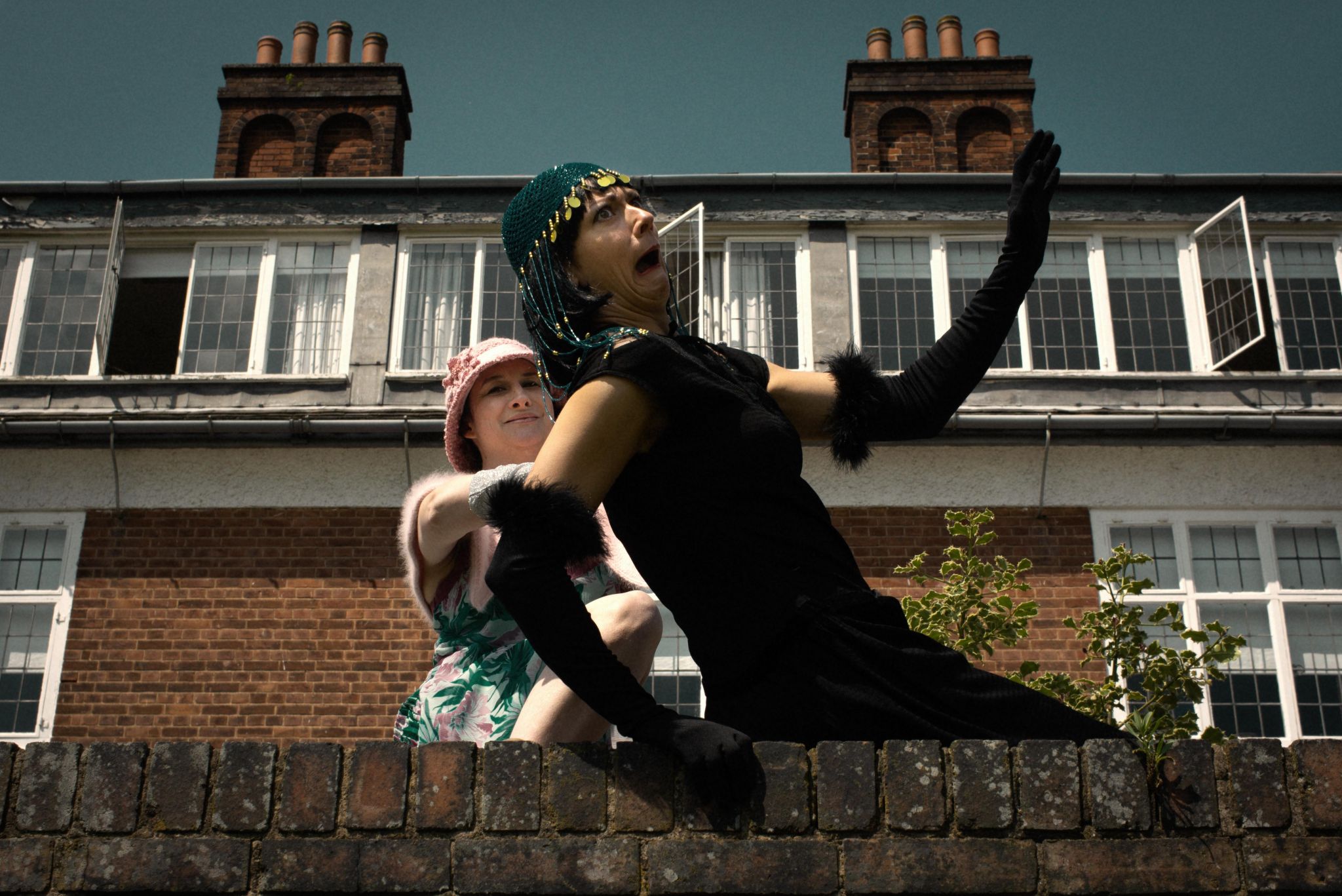 Two actors performing in front of Winterbourne House