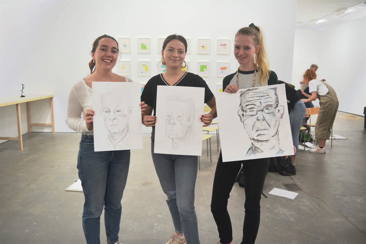 students showing their finished life drawings