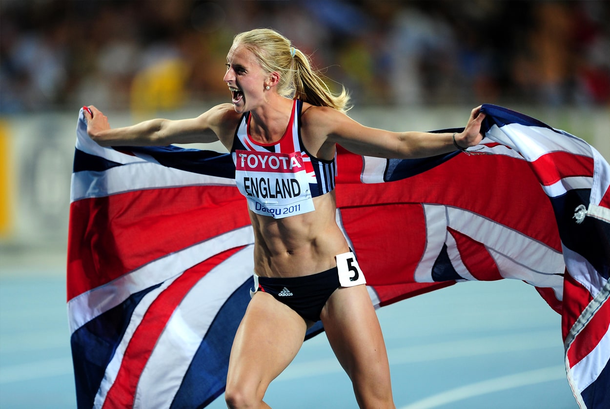Hannah England runs along holding a union flag behind her after winning silver in the 1500m at the 2011 World Championships in Daegu