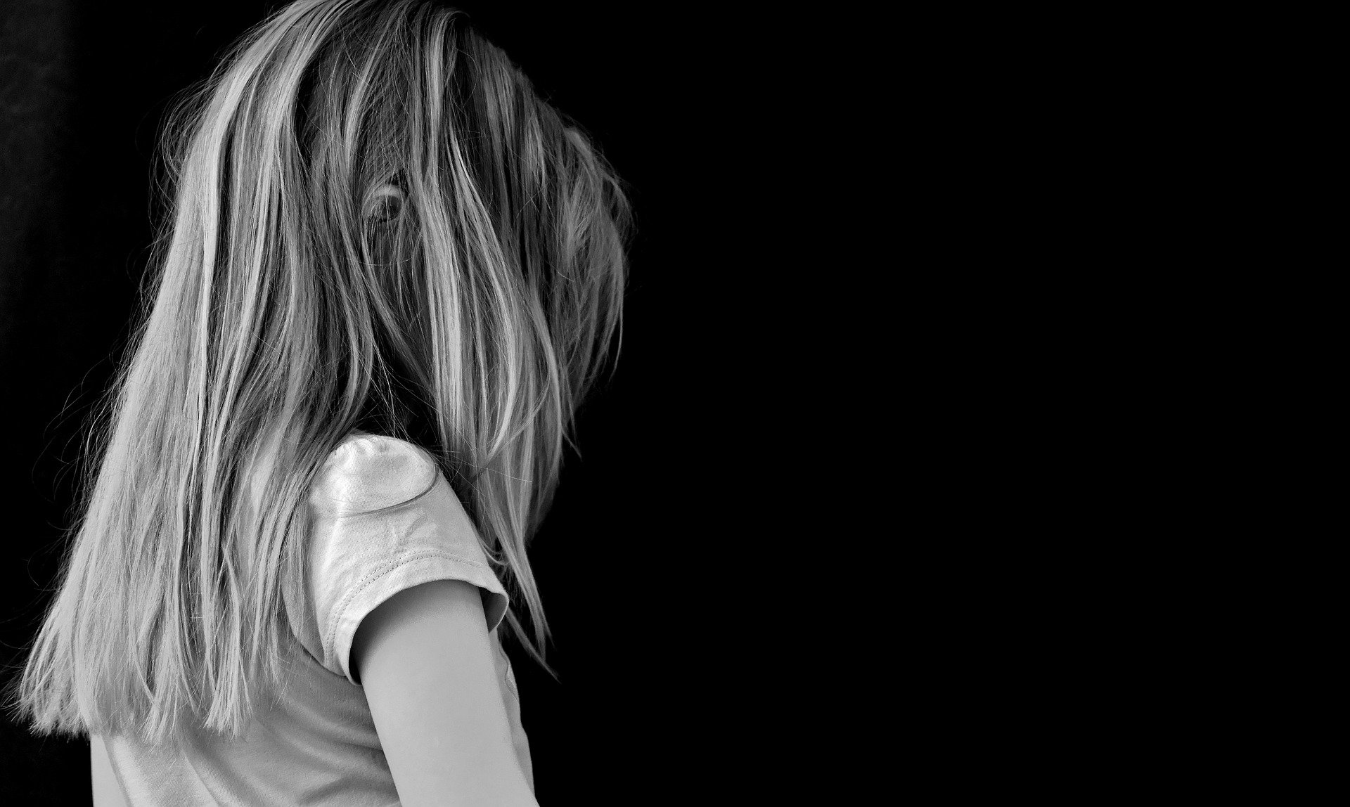 Grey scale image of young girl facing away from the camera