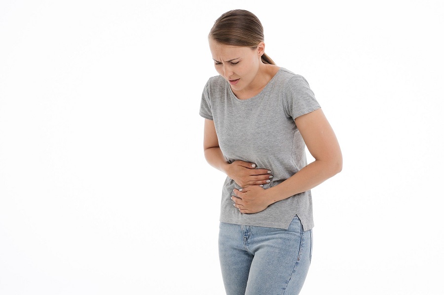 Woman holding stomach area as if in pain