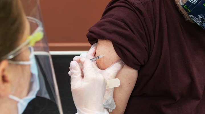 a close up of a person receiving a vaccine injection