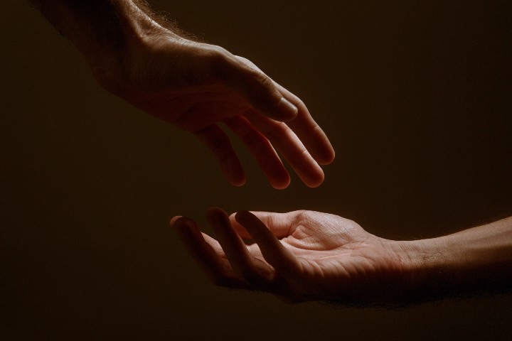 hands reaching towards each other